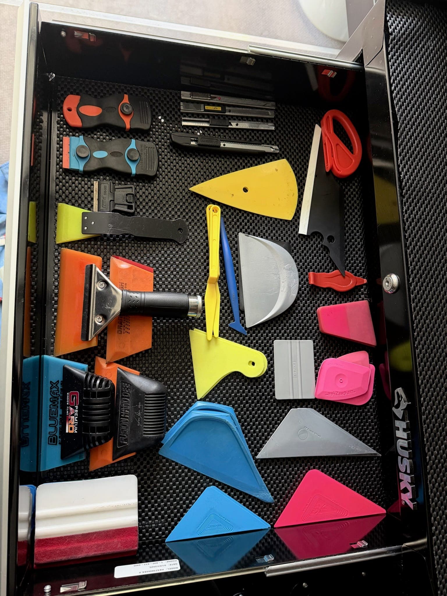 Tray of professional window-tinting tools and squeegees